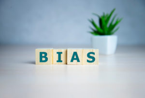 The word 'bias' in wooden blocks with a small succulent behind